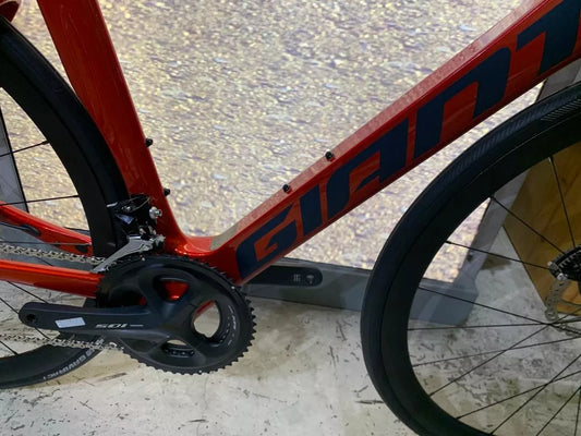 a close up of a red bike with black spokes