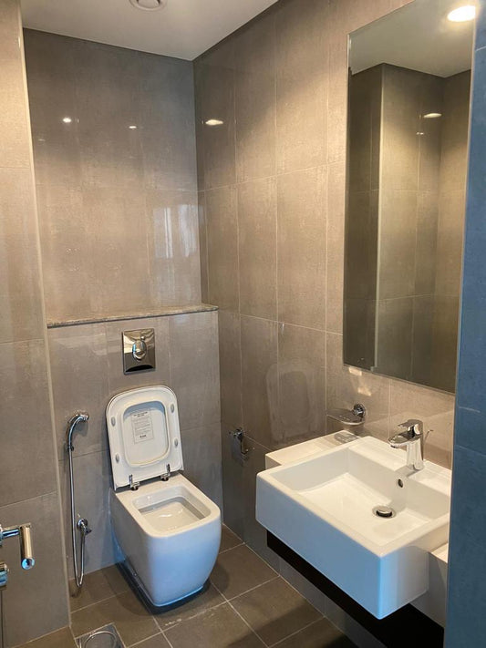 a white toilet sitting next to a white sink