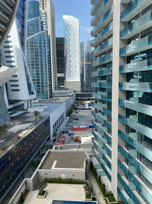 an aerial view of a city with tall buildings