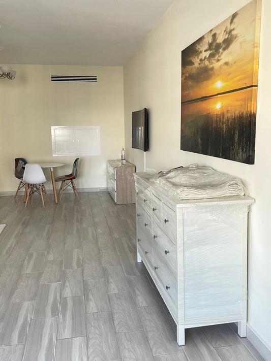 a living room with a large painting on the wall