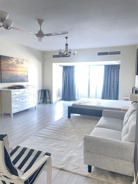 a living room filled with furniture and a flat screen tv