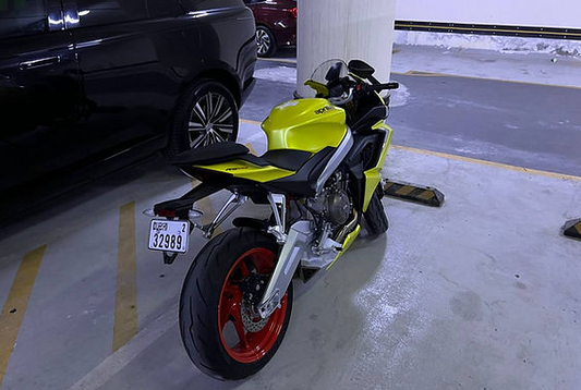 a yellow and black motorcycle parked in a parking garage